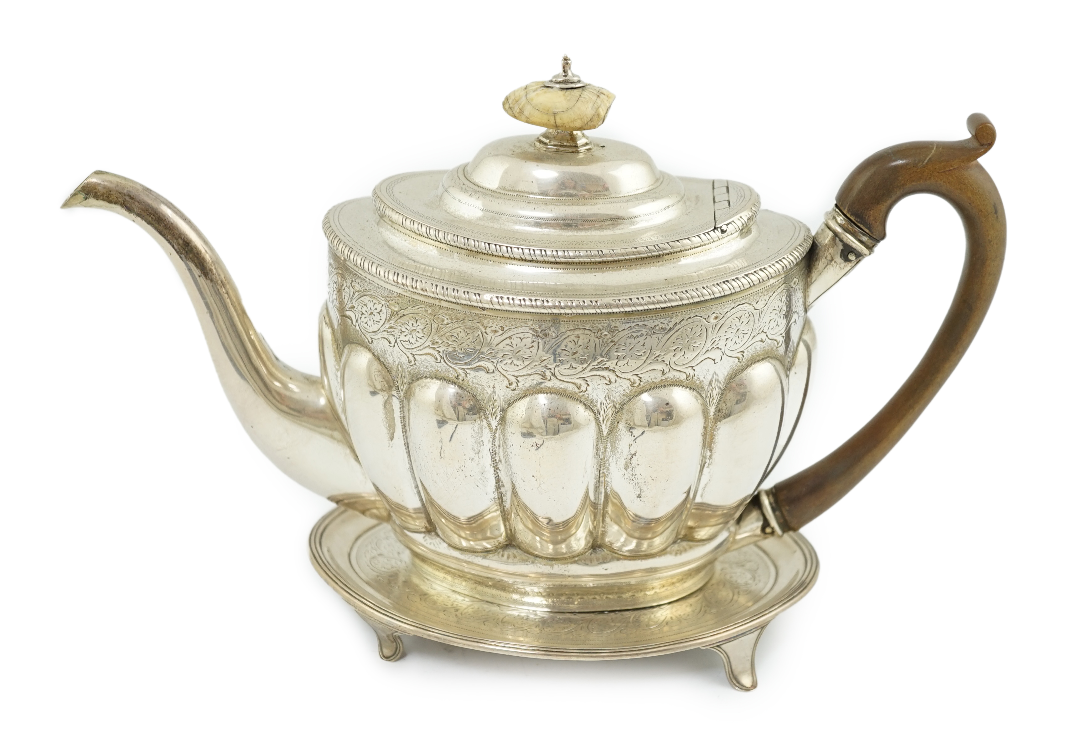 A George III engraved silver oval teapot by Soloman Hougham, together with a George III silver oval teapot stand, by John Eames, 16.8cm, CITES Submission reference YNZWLYTV